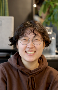이지윤 기자가 카메라를 바라보며 미소짓고 있다.