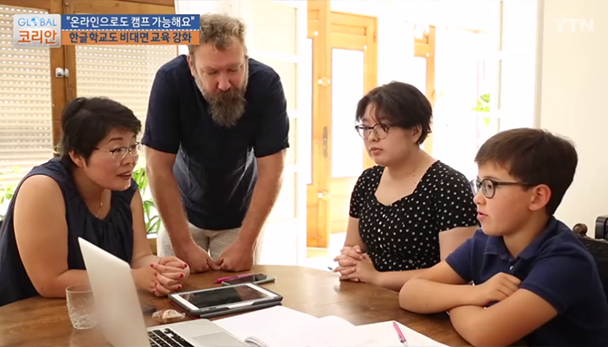 ‘온라인캠프 한글학교’에 참여한 외국인 가족. 부모님과 딸, 아들이 함께 테이블에 모여 노트북을 응시하며 한글을 배우고 있다.