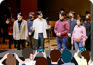 한빛예술단의 공연 사진이다. 사진을 향해 많은 관람객이 손을 치켜들고, 핸드폰을 꺼내 촬영하고 있는 그림이 그려져 있다.