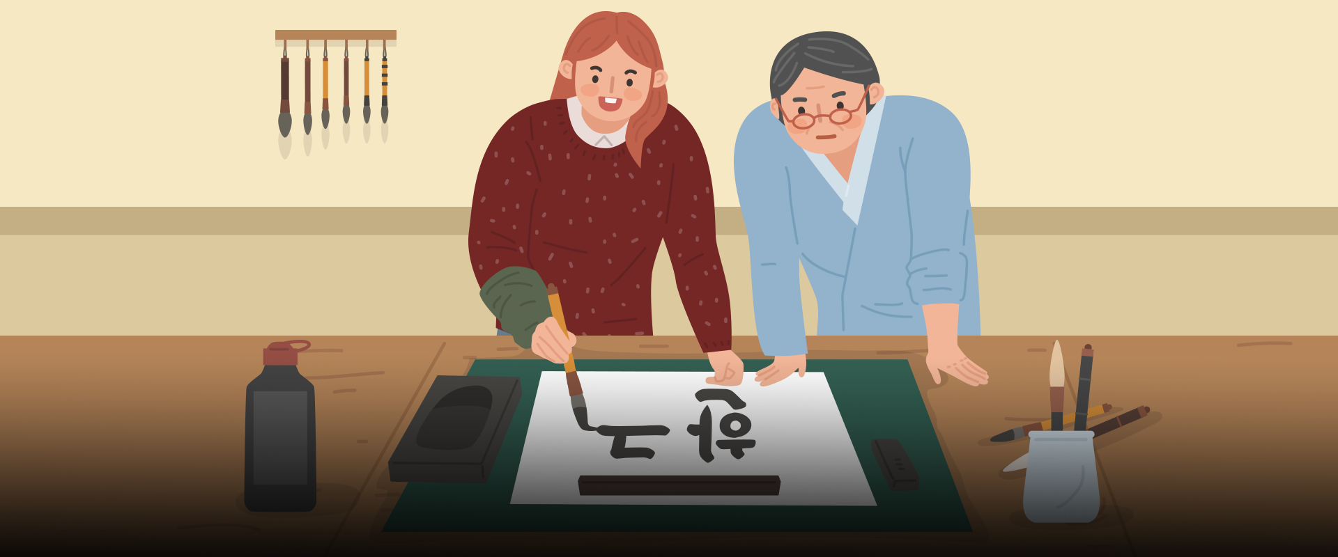 한글 이모저모 사진. 서예 연습을 하고 있는 두 사람이 나란히 서 있는 일러스트가 그려져 있다. 왼쪽엔 붉은색 니트를 입고 있는 여성이 붓을 들고 글씨를 쓰고 있다. 오른쪽에는 하늘색 한복을 입은 남성이 탁자를 손으로 짚고 여성이 쓰고 있는 글씨를 들여다보고 있다. 탁자에는 먹물통과 벼루, 붓 등 서예 도구가 놓여 있다. 왼쪽 하단에는 주황색 박스 안에 ‘한글 이모저모’ 문구가 적혀있다. 그 아래에는 기사의 제목인 ‘국가무형유산으로 지정된 한글서예, 기록 수단을 넘어 문화예술적 가치 인정’이라고 적혀있다.